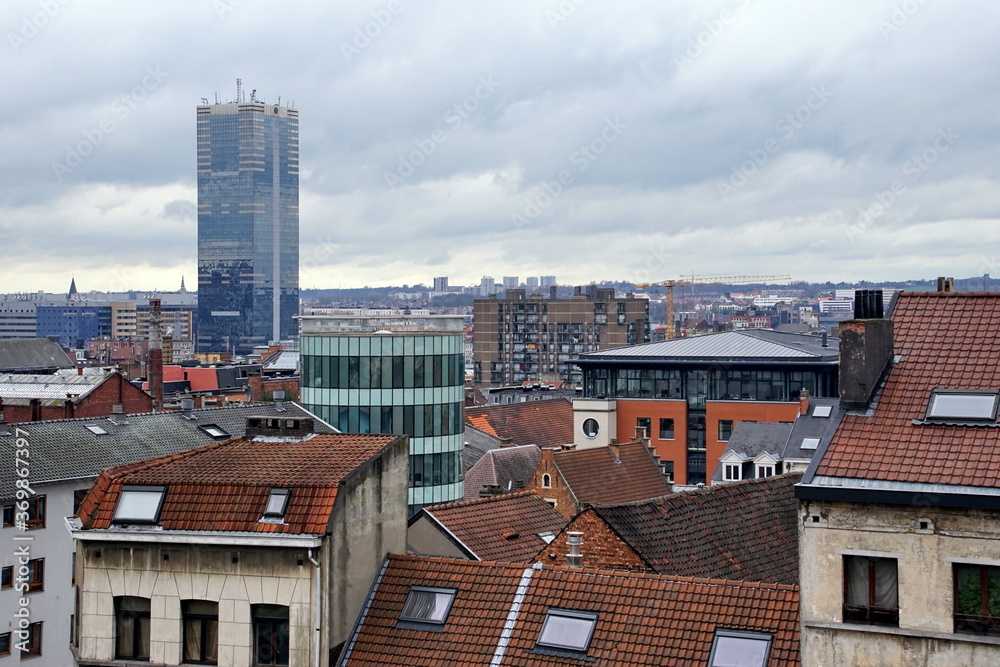 view of oldtown architecture with red tiled rooftops and modern cityscape in background, Brussels, Belgium