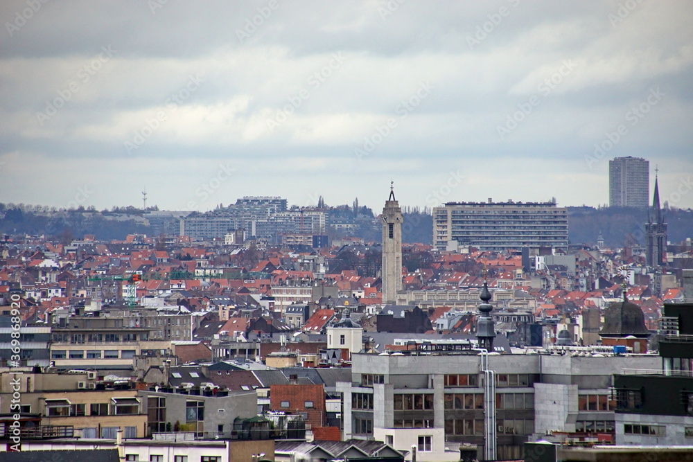 view of oldtown architecture with red tiled rooftops and modern cityscape in background, Brussels, Belgium