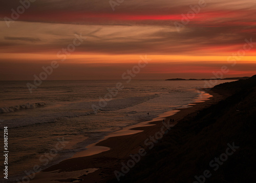 Colourful sunset at the beach, extended coastline with sand in Australia