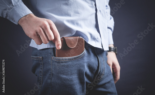 Man putting wallet in his pocket.
