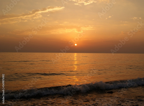 Beautiful dawn over the sea. Sunny path on the water. Light wave and swell on the surface of the water