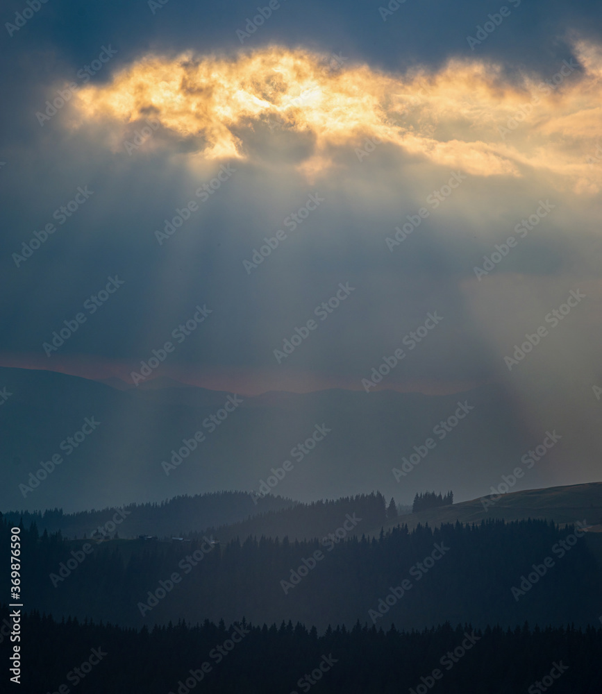 The sun's rays Breaking through the clouds The sun's rays Breaking through the clouds