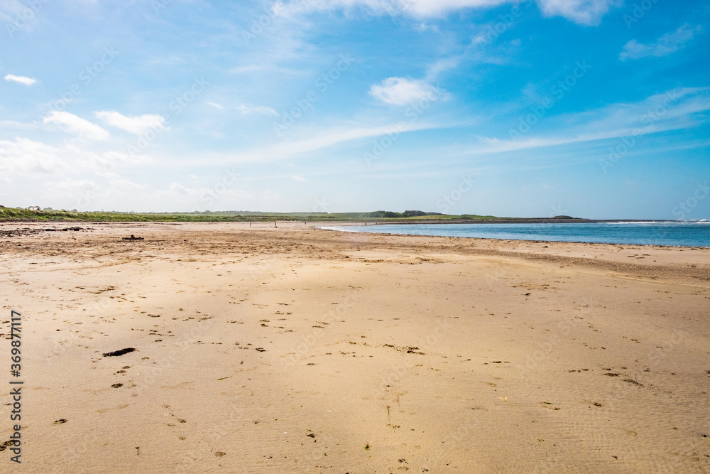 A beach at the north coast of Scotland, on a sunny day.