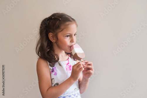 The girl eats ice cream. Stylish girl bites ice cream