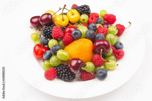 assortment of fresh berries on a white plate. useful vitamin healthy food fruit. healthy vegetable breakfast