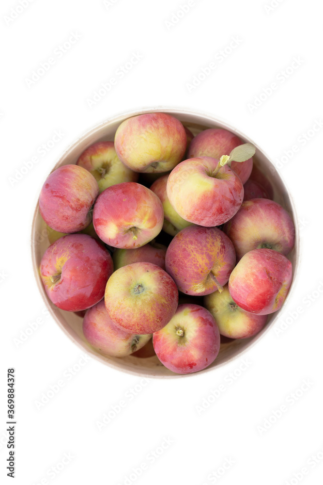 Red apples in bucket isolated on white. Top view with copyspace. Red apples in bucket isolated on white. Top view with copyspace.