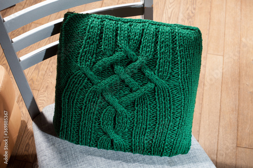 knitted cushion lying on the chair, to improve orthopedics back of the chair