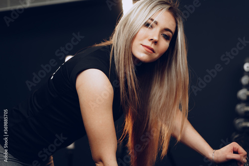 Portrait of a young woman in sportswear posing in a gym © fotofabrika