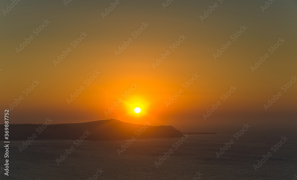 The beautiful warm Santorini sunset in Greece