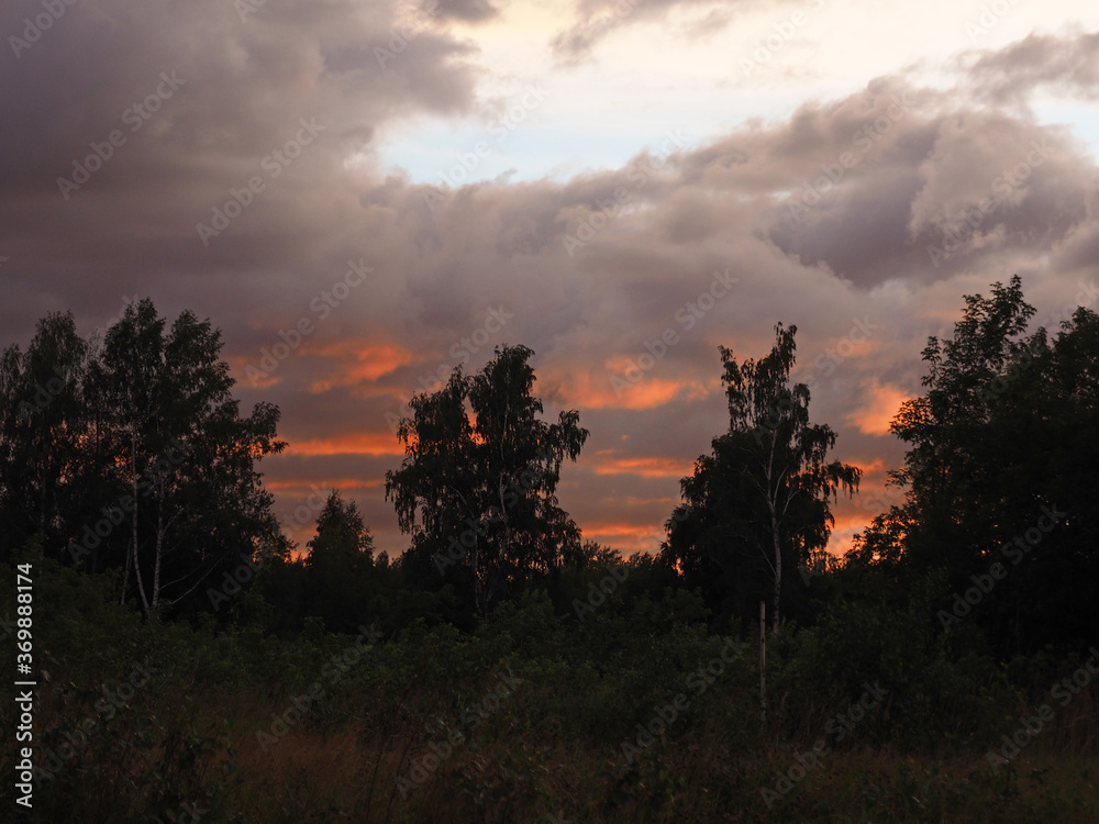 Thunderous sunset over the forest. Russia, Ural.