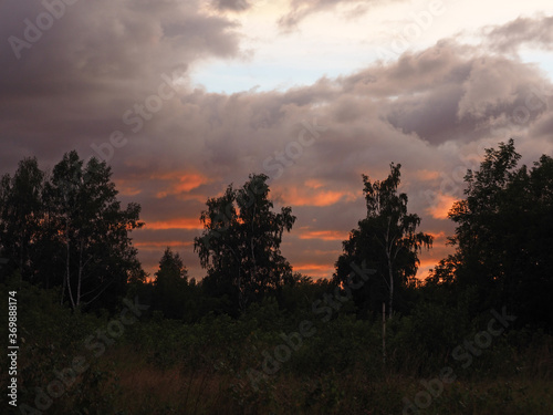 Thunderous sunset over the forest. Russia, Ural.