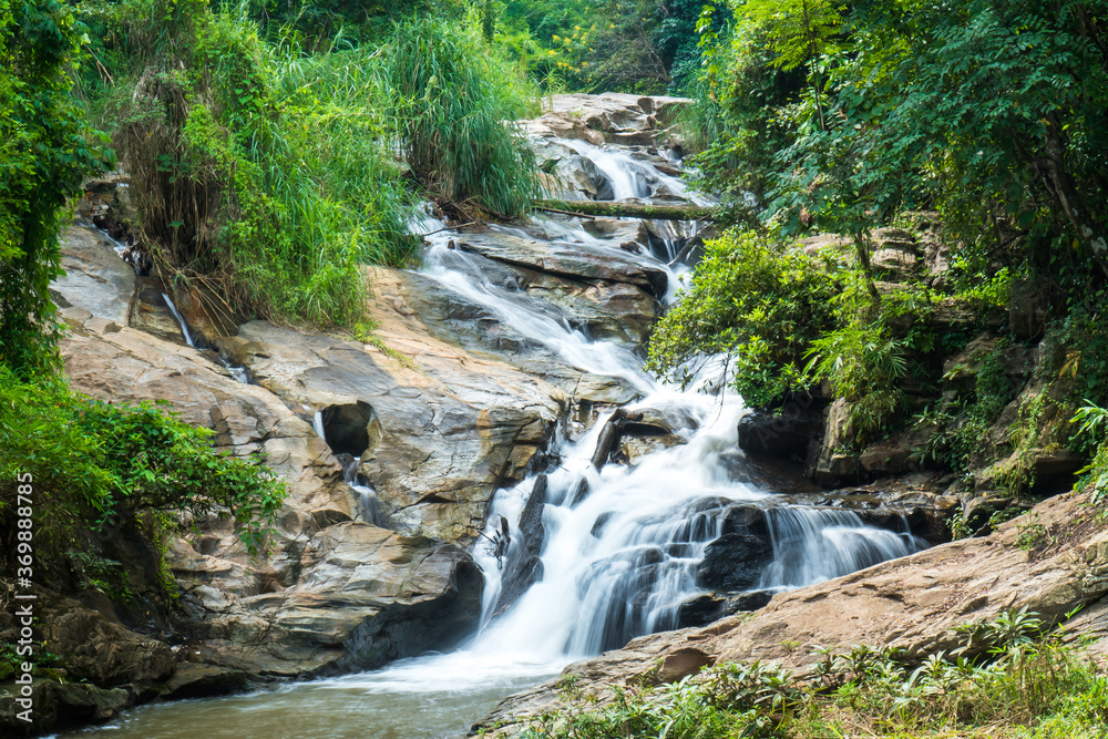 Closeup of Mae Sa waterfall in Chiang Mai, Thailand. Fresh green maesa waterfall with rock and trees background Closeup of Mae Sa waterfall in Chiang Mai, Thailand. Fresh green maesa waterfall with rock and trees background