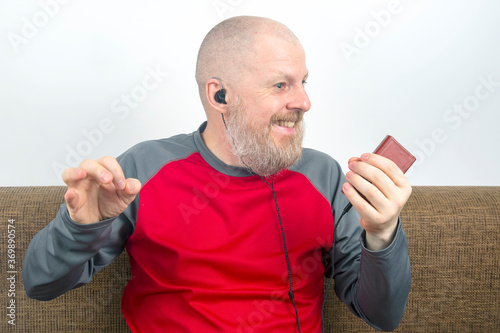 bearded man likes to listen to his favorite music at home with an audio player in small headphones. audiophile and music lover. music and hi-fi sound.