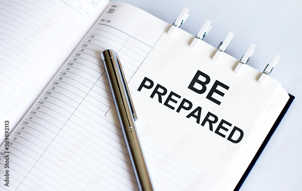text BE PREPARED on the short note texture background with pen