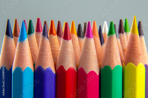 set of color pencils on a gray background. drawing tools. palette in creativity