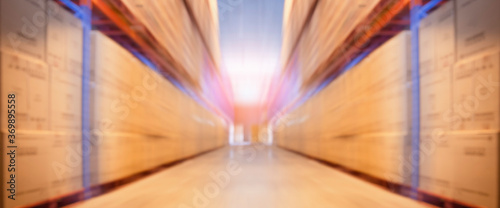 Blurred Warehouse inventory cargo storage with tall shelves. Panorama view, Business and Industrial logistics background.