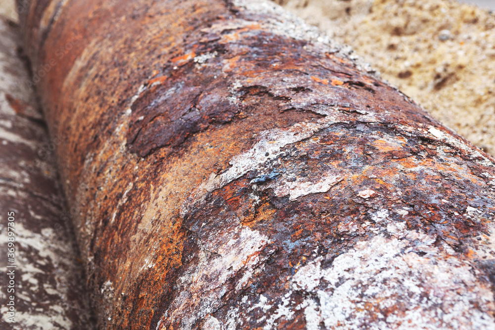 Fragments of old large water pipes. After many years of operation, corroded metal pipe destroyed. Rusty steel tube with holes metal corrosion. Selective focus. Fragments of old large water pipes. After many years of operation, corroded metal pipe destroyed. Rusty steel tube with holes metal corrosion. Selective focus.