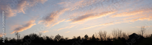 Purple-magenta clouds. Cirrus cloudscape on blue sky.Tragic gloomy sky. Landscape with bloody sunset. Fantastic skies on the planet earth.