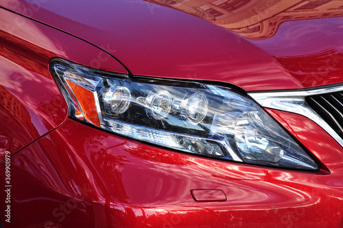 Closeup headlights red car © ankihoglund