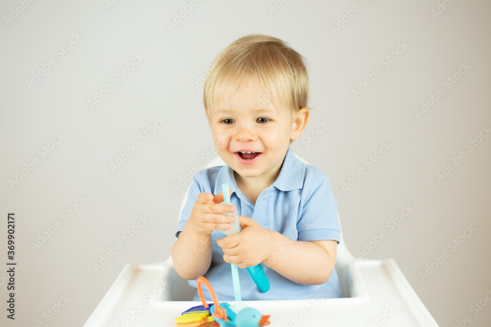 Portrait of a beautiful blond baby sitting smiling Portrait of a beautiful blond baby sitting smiling