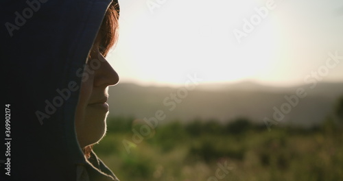 Photography The movement of the camera to the left changes the focus to a young woman with a hood looking forward