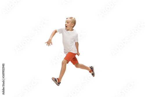 Target. Happy kids, little and emotional caucasian boy jumping and running isolated on white background. Look happy, cheerful, sincere. Copyspace for ad. Childhood, education, happiness concept.