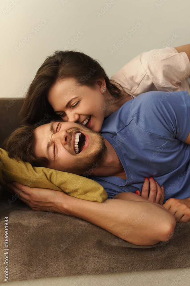 Young and happy couple lying on a sofa Young and happy couple lying on a sofa