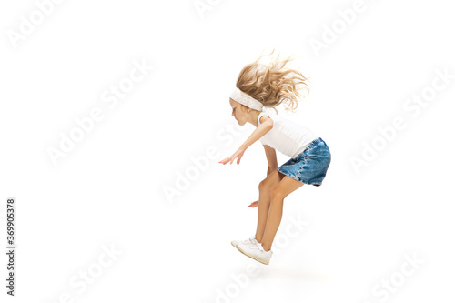 Fototapeta Naklejka Na Ścianę i Meble -  High. Happy kids, little and emotional caucasian girl jumping and running isolated on white background. Look happy, cheerful, sincere. Copyspace for ad. Childhood, education, happiness concept.