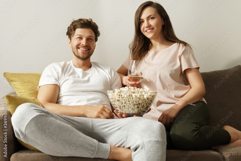 Happy couple drinking wine and relaxing at home Happy couple drinking wine and relaxing at home