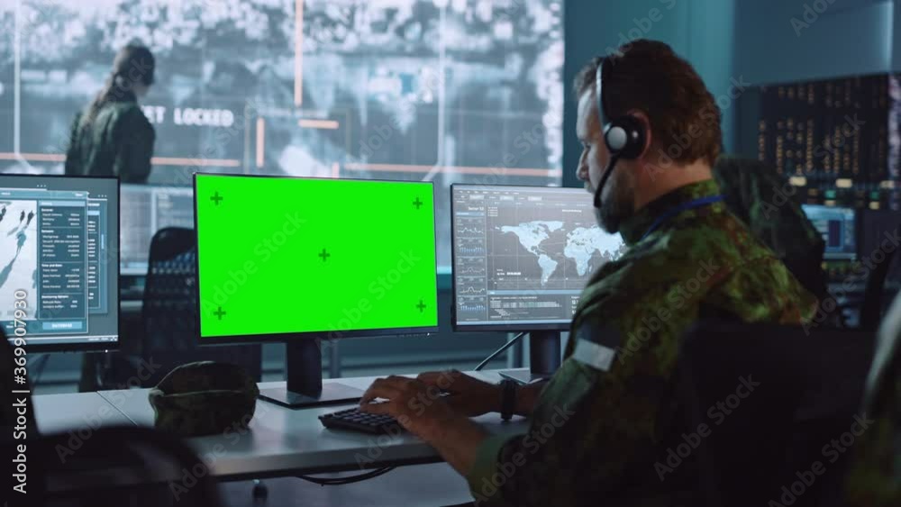 Military Surveillance Officer Working on Computer with Green Screen in Central Office for Cyber Operations, Control and Monitoring for Managing National Security, Technology and Army Communications.