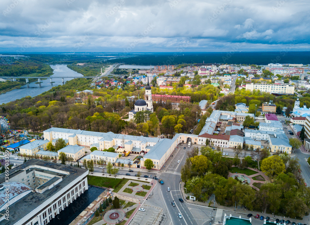 Aerial panoramic view of modern cityscape of Kaluga on banks of Oka river overlooking black domes of Holy Trinity Cathedral