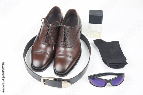 Classic men's shoes, belt and glasses on white background