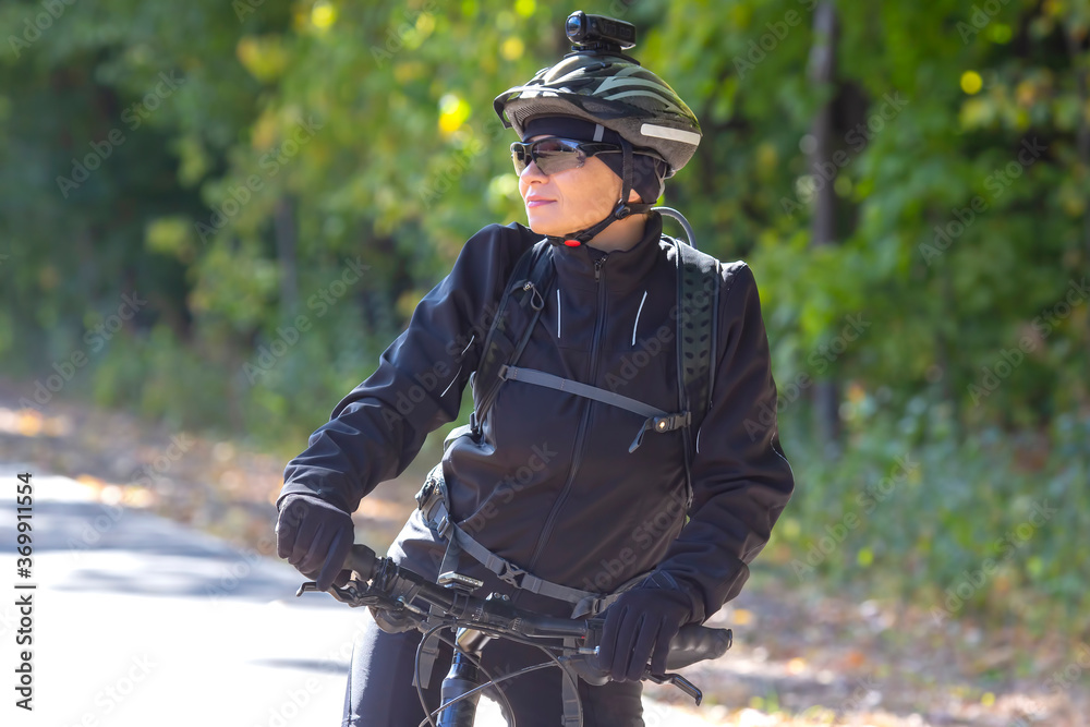 Beautiful girl cyclist rides a bicycle. Healthy lifestyle and sport. Leisure and hobbies Beautiful girl cyclist rides a bicycle. Healthy lifestyle and sport. Leisure and hobbies