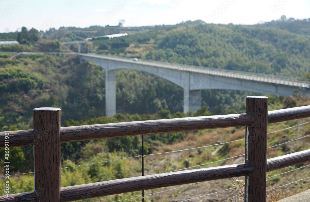 Road bridge across the valley and fence of the mountain observatory Road bridge across the valley and fence of the mountain observatory