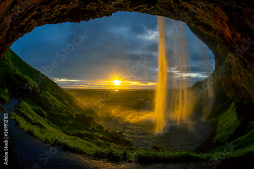 Seljalandsfoss waterfall against the backdrop of a bright sunset. Iceland
