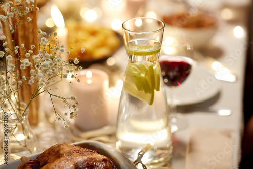 eating, holiday and dinner party concept - roast chicken in baking dish on se...