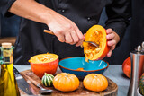 chef chopping pumpkins for pumpkin soup