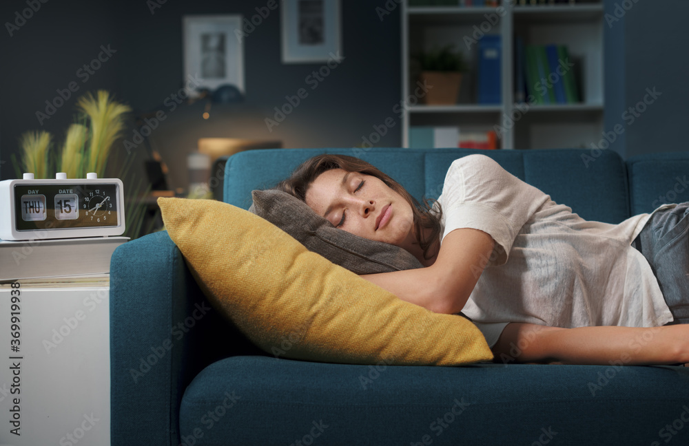 © StockPhotoPro - Relaxed woman sleeping on the sofa at home