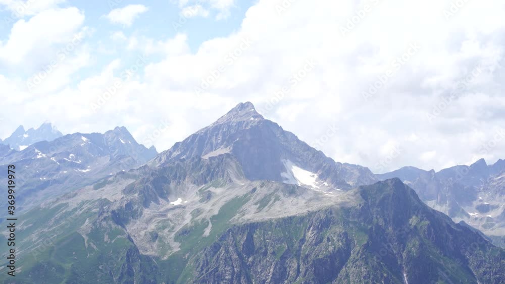Peaks of magnificent rocks located against bright cloudy sky on sunny day in nature Peaks of magnificent rocks located against bright cloudy sky on sunny day in nature