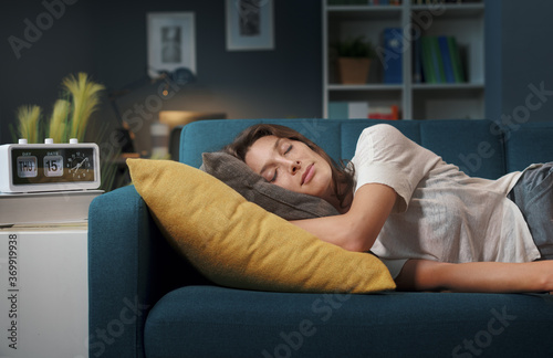 Relaxed woman sleeping on the sofa at home