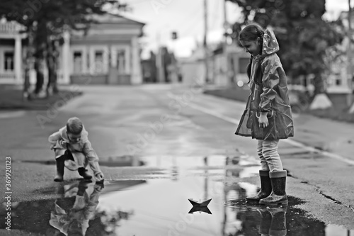 paper boat in a puddle of rain / autumn weather concept childhood