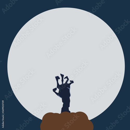Zombie hand that crawls out of the ground against the background of the moon in halloween