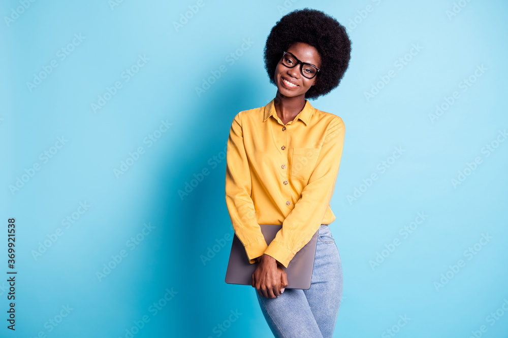 Photo of black skin big volume hairstyle woman hold netbook shiny smiling  prepare university homework friends library wear specs jeans yellow shirt  isolated blue color background Stock Photo | Adobe Stock