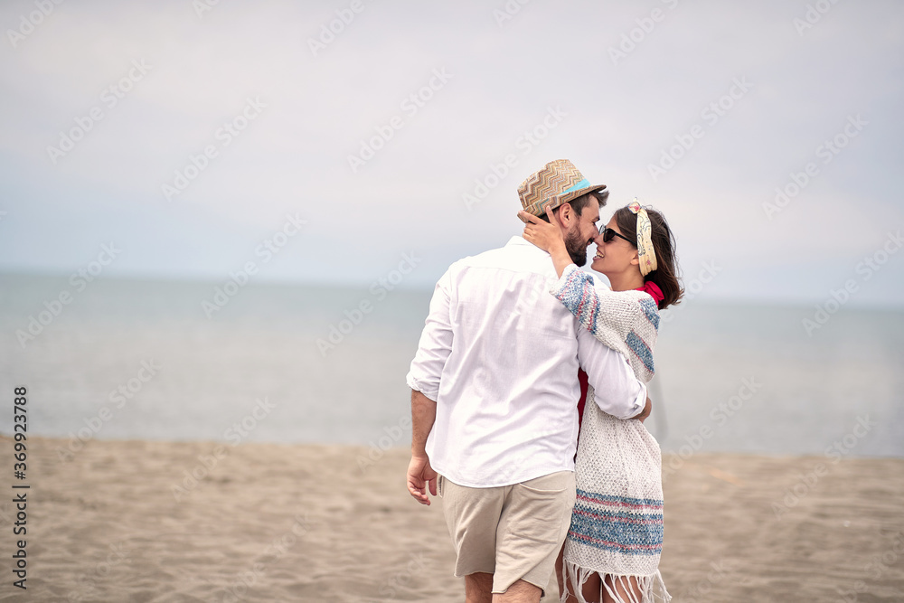young adult couple is about to kiss at beach