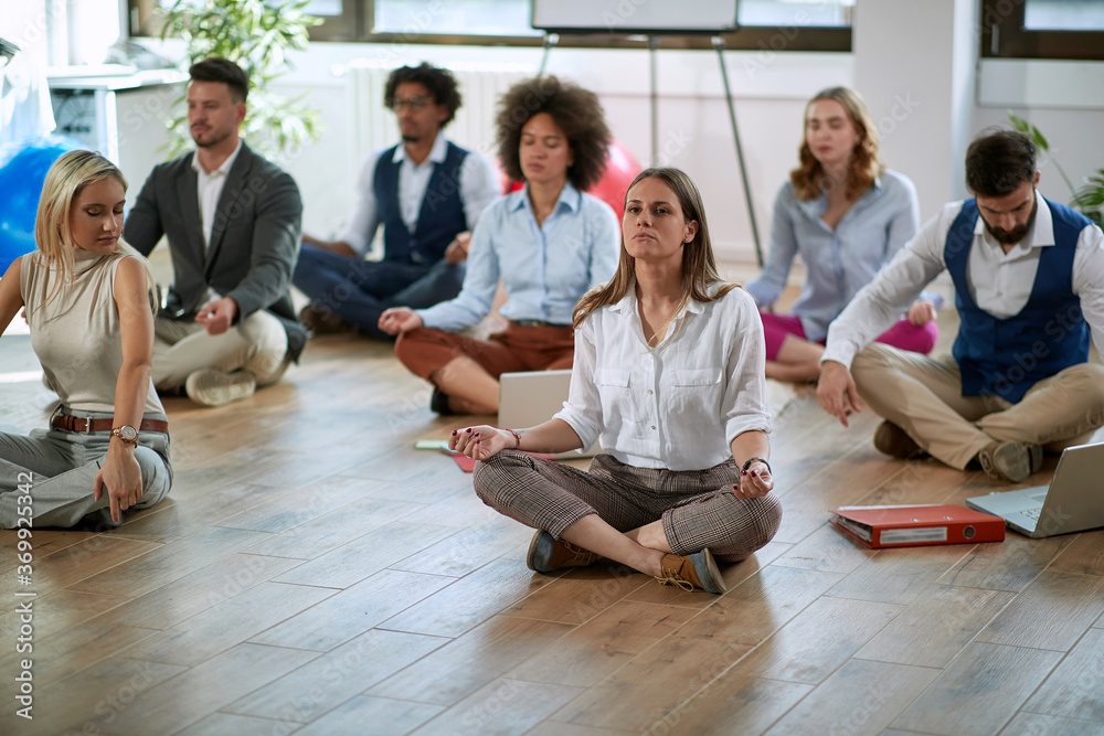 Young colleagues having yoga in the office Young colleagues having yoga in the office