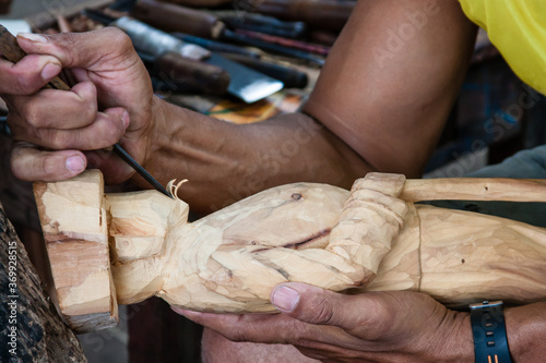 An artist carving wood