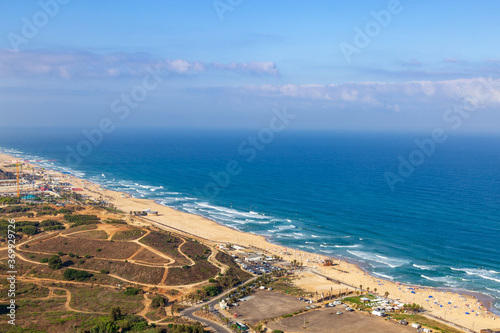 View of the Mediterranean coast from a high skyscraper. The beaches of the cities of Bat Yam and Rishon Le Zion are visible. Panorama. Israel. Summer.