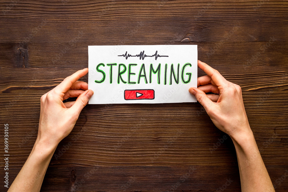 Live streaming web network concept. Female hands holding paper tablet. Top view Live streaming web network concept. Female hands holding paper tablet. Top view
