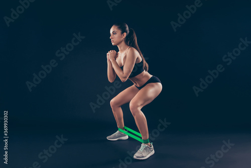 Profile side view portrait of her she nice-looking attractive sportive perfect strong slim thin lady working out sit ups life improvement isolated over black background