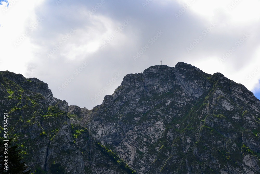 Giewont with cross on the top. Mountain massif in the Tatra Mountains of Poland. A mountain-symbol, whose profile is associated with the silhouette of a sleeping knight Giewont with cross on the top. Mountain massif in the Tatra Mountains of Poland. A mountain-symbol, whose profile is associated with the silhouette of a sleeping knight